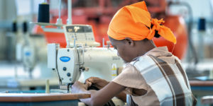 A textile worker in Ethiopia at a sewing machine.
