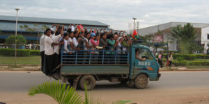 Photograph of workers in a truck