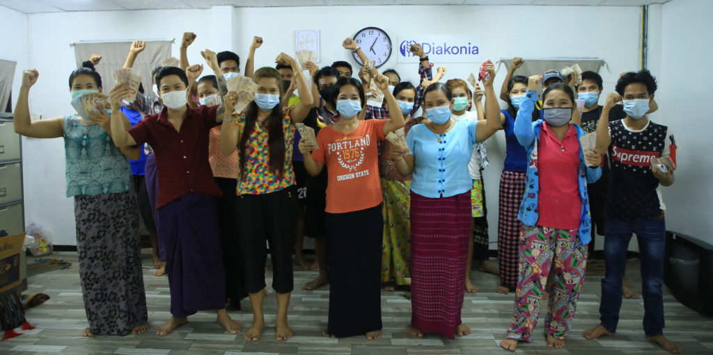 Burmese Workers in Thailand showing their severance money