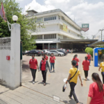 Hong Seng factory with workers entering and exiting the campus