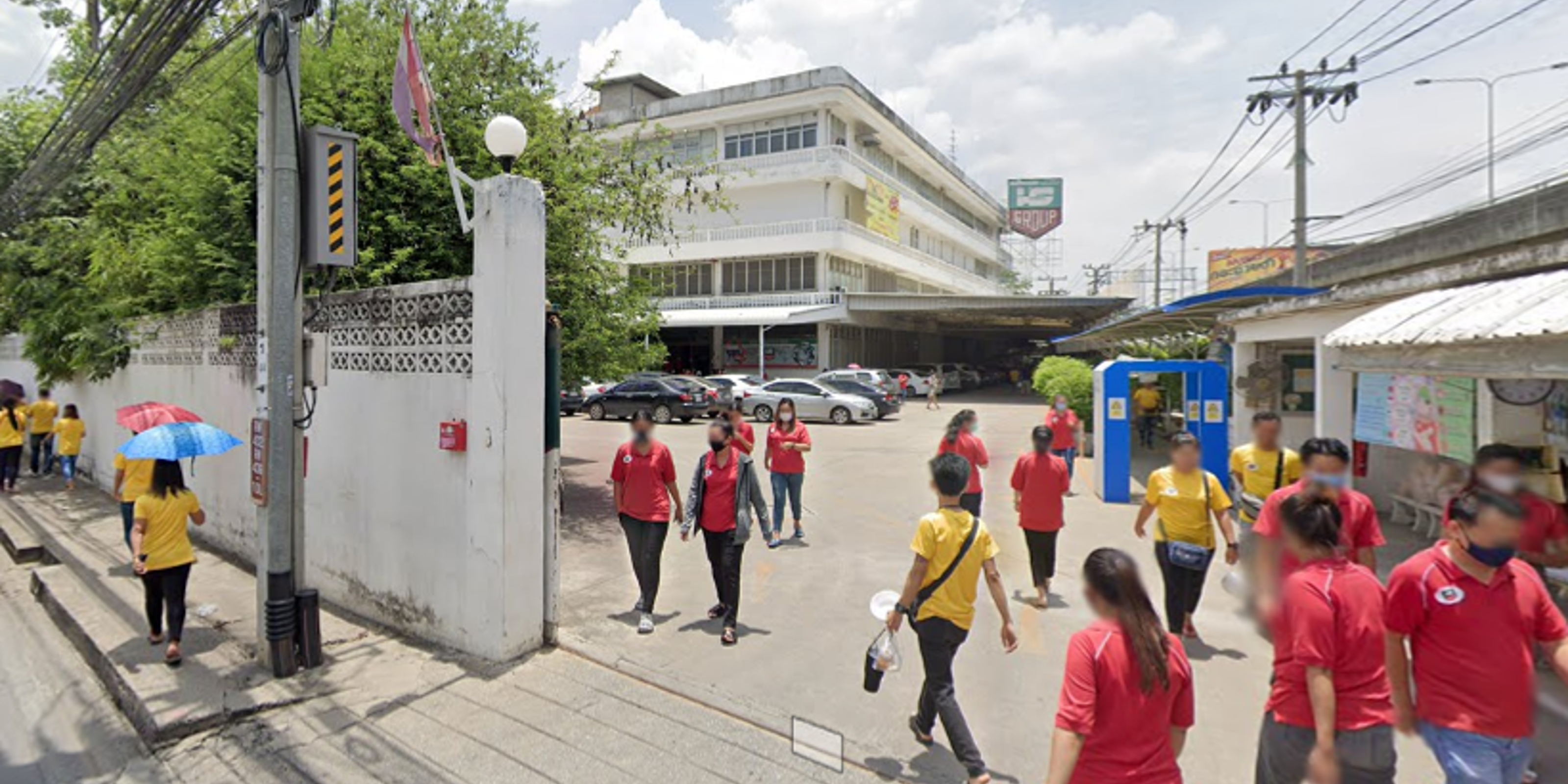 Hong Seng factory with workers entering and exiting the campus